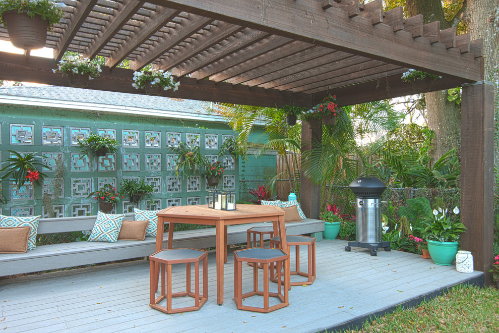 Foto di un patio o portico moderno dietro casa con pedane e una pergola