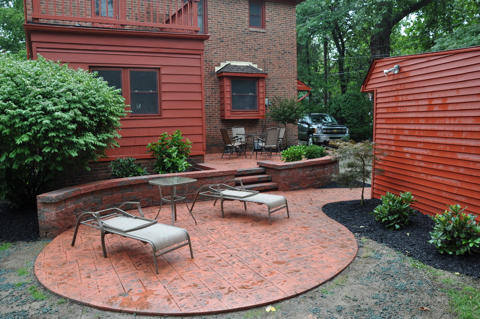 This is an example of a small contemporary back patio in Cleveland with stamped concrete and no cover.