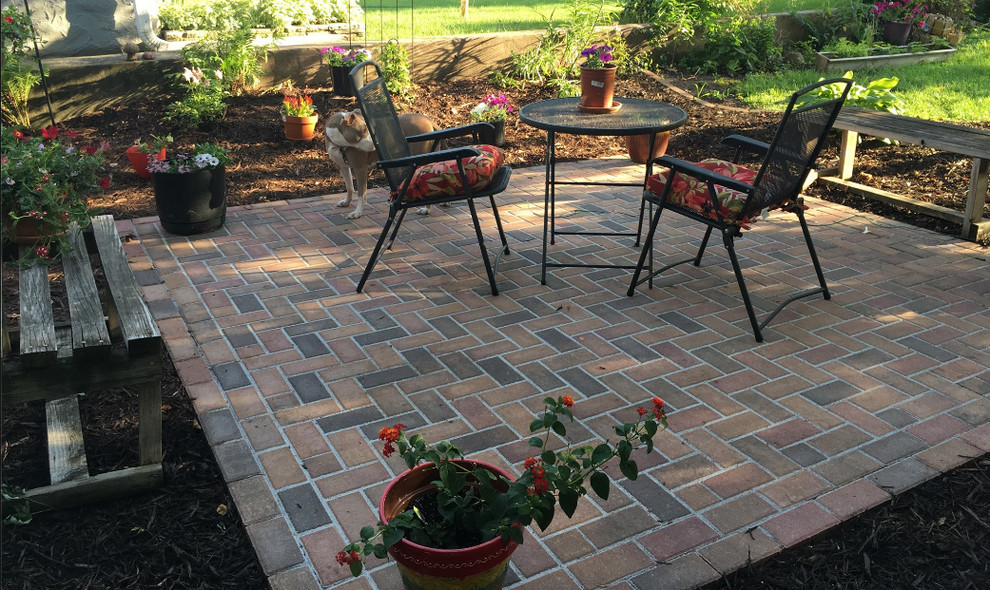 Photo of a medium sized traditional back patio in Minneapolis with brick paving and no cover.