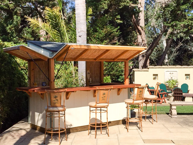 This is an example of a medium sized world-inspired back patio in Santa Barbara with an outdoor kitchen, concrete paving and an awning.