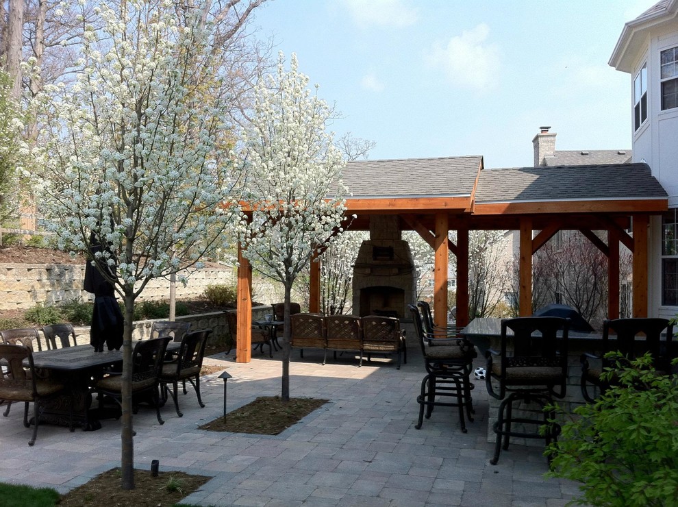 Aménagement d'une terrasse arrière classique de taille moyenne avec des pavés en béton, une cuisine d'été et une pergola.
