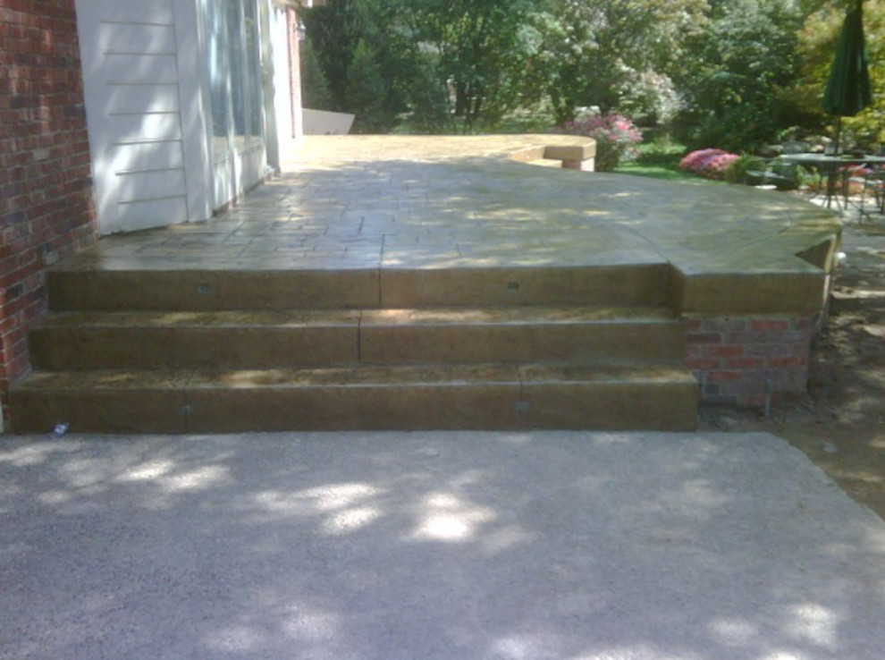 Example of a classic backyard concrete paver patio design in Louisville with no cover