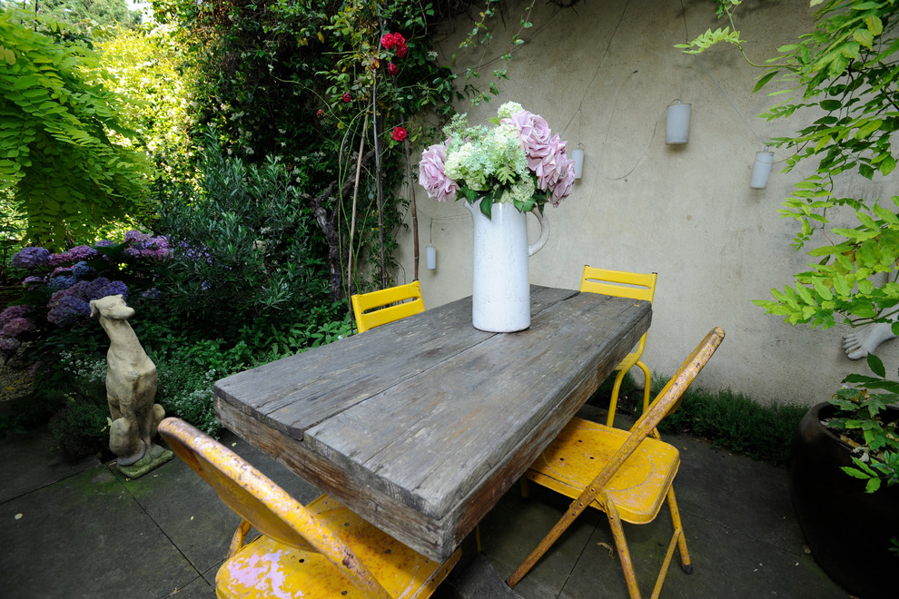 Inspiration for a shabby-chic style courtyard patio remodel in London