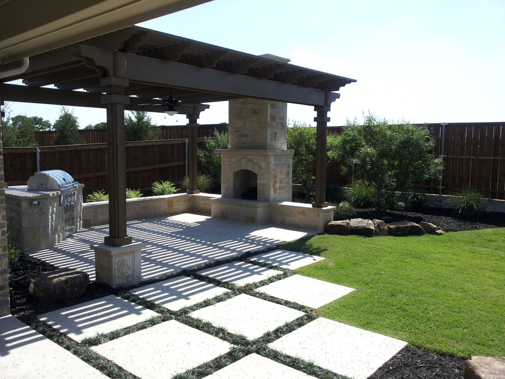 Inspiration for a mid-sized timeless backyard concrete patio kitchen remodel in Dallas with a pergola