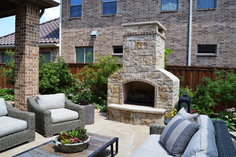 Example of a mid-sized classic backyard stone patio kitchen design in Dallas with a pergola