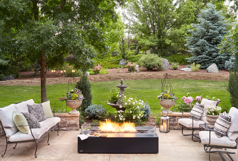 This is an example of a traditional patio in Denver with a fire feature and no cover.