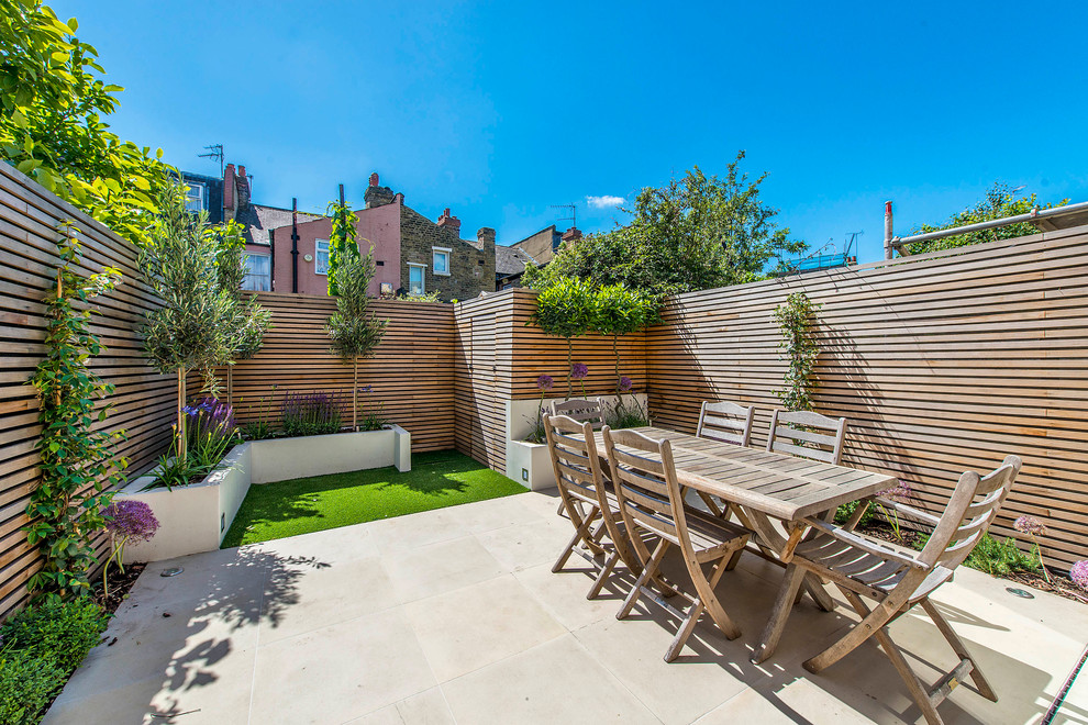 Patio - small contemporary backyard concrete paver patio idea in London with no cover