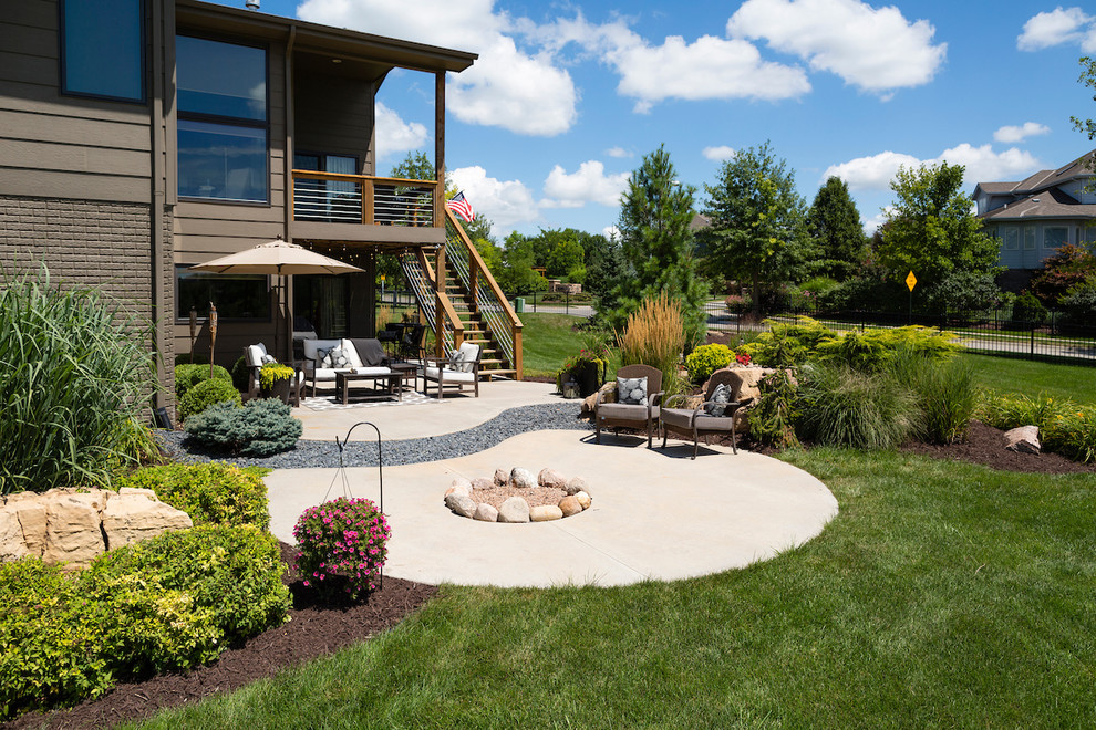 Rustic patio in Omaha with a water feature.