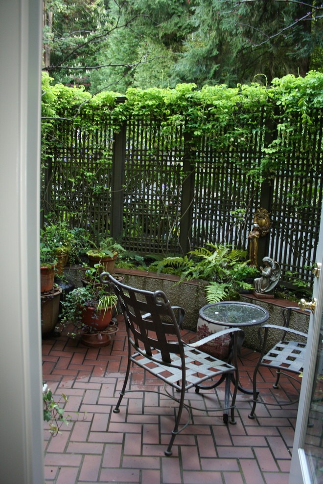 Patio - small asian front yard brick patio idea in Portland with no cover