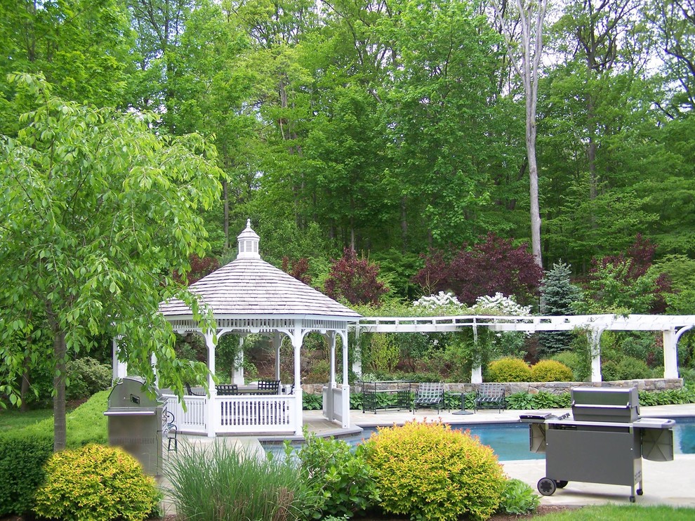 Traditional back patio in New York with a gazebo and a bbq area.