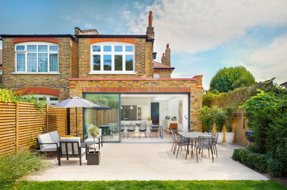 Design ideas for a medium sized contemporary back patio in London with no cover.