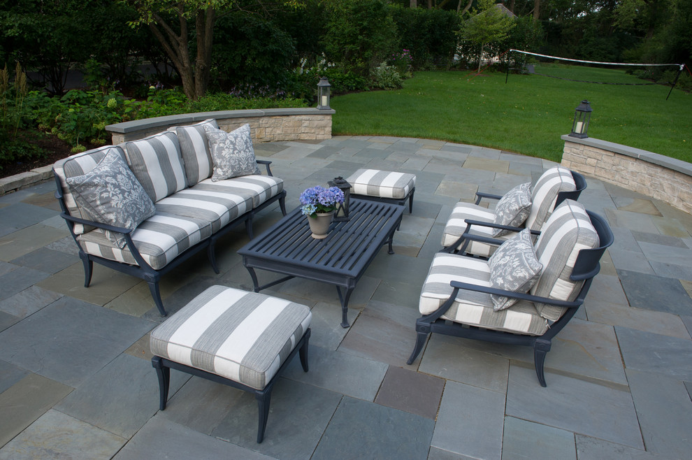 This is an example of a classic back patio in Chicago with natural stone paving.