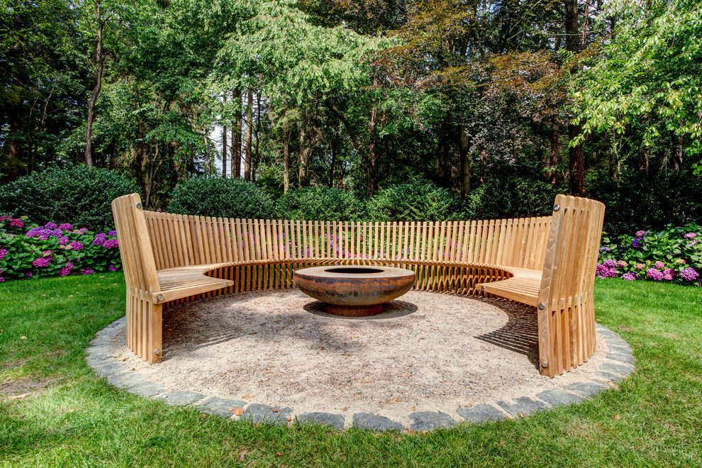 Patio - mid-sized country patio idea in Hamburg with a fire pit and no cover