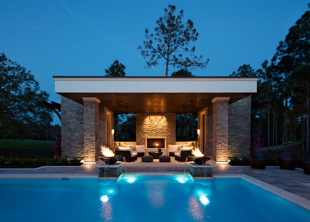 Example of a large transitional backyard tile patio design in Miami with a fire pit and a pergola