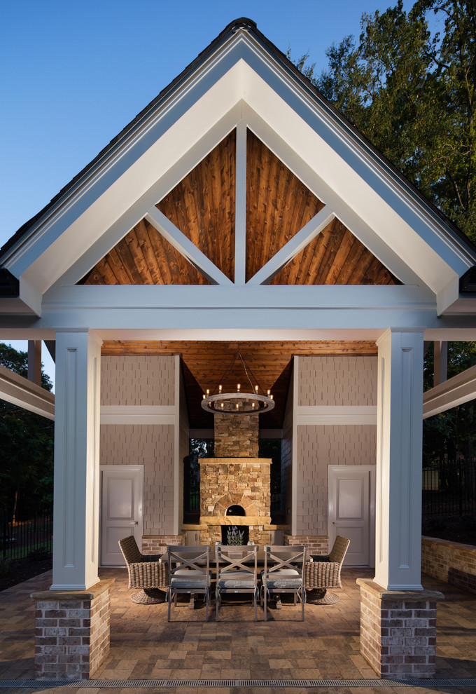 Photo of a large traditional back patio in Atlanta with an outdoor kitchen, concrete paving and a gazebo.