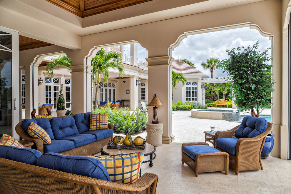 Photo of a world-inspired patio in Miami with a roof extension.