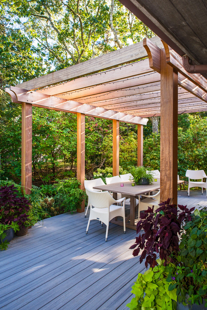 Ispirazione per un grande patio o portico stile marino dietro casa con un focolare, pedane e una pergola