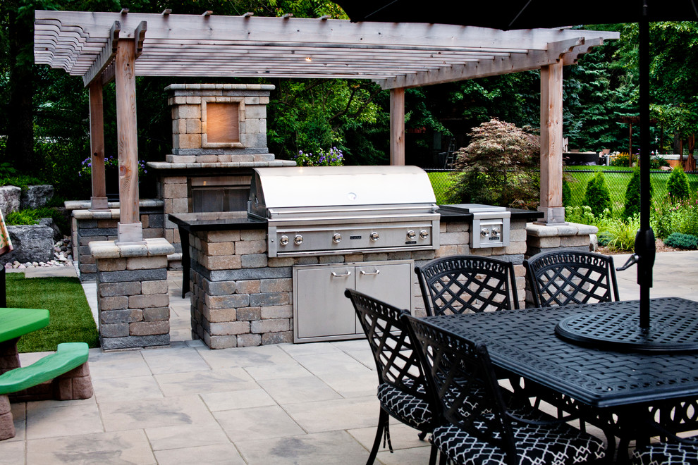 Large elegant backyard concrete paver patio photo in Toronto with a fire pit and a pergola