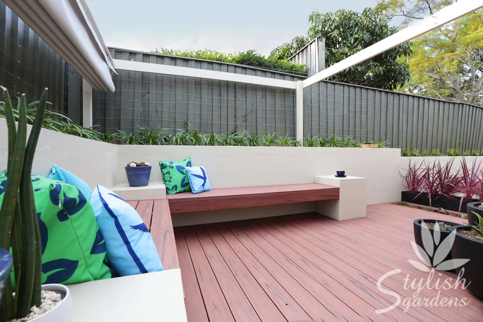 Inspiration for a small modern back patio in Sydney with a potted garden, decking and an awning.