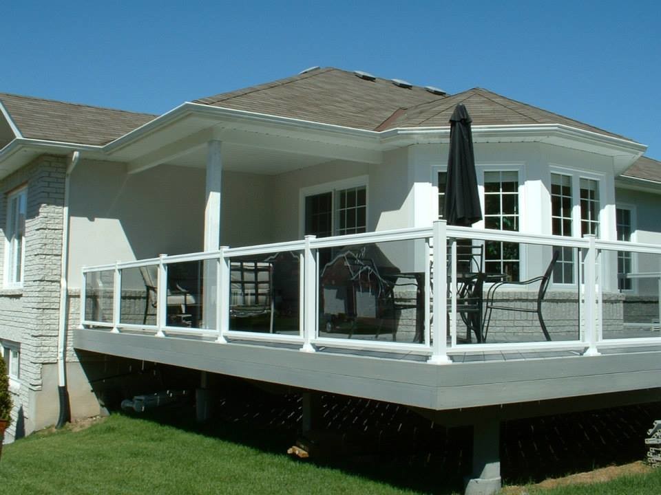 Cette photo montre une terrasse en bois arrière chic de taille moyenne avec une extension de toiture.