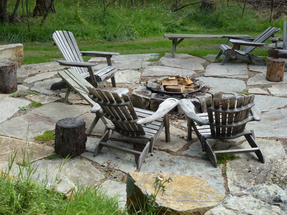 Example of a mid-sized arts and crafts side yard patio design in Seattle with a fire pit and no cover