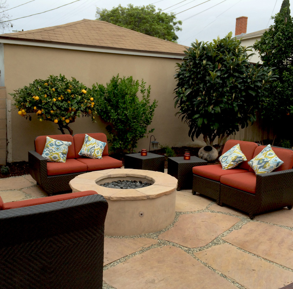 Foto de patio clásico renovado de tamaño medio sin cubierta en patio trasero con brasero y adoquines de piedra natural