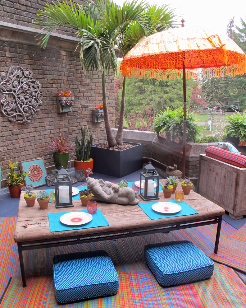 Small eclectic patio container garden photo in New York with decking