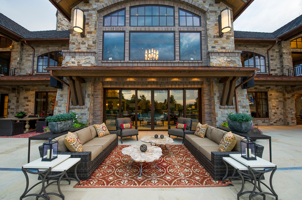 Inspiration for a huge rustic backyard tile patio remodel in Denver with a roof extension