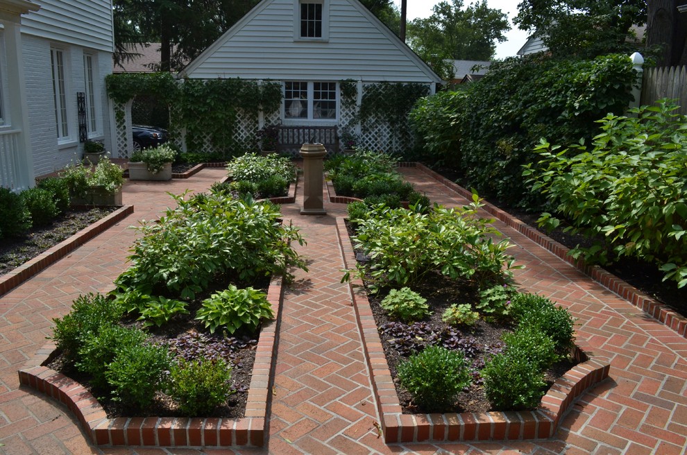 Immagine di un grande giardino minimal dietro casa con pavimentazioni in mattoni e un giardino in vaso
