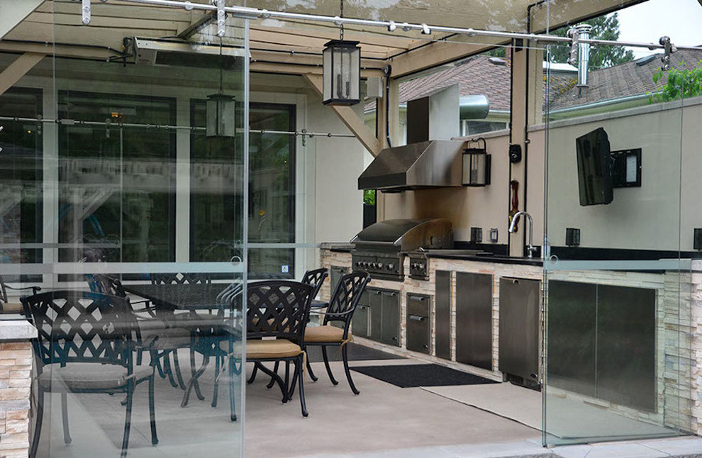 Mid-sized trendy courtyard tile patio kitchen photo in Vancouver with a pergola