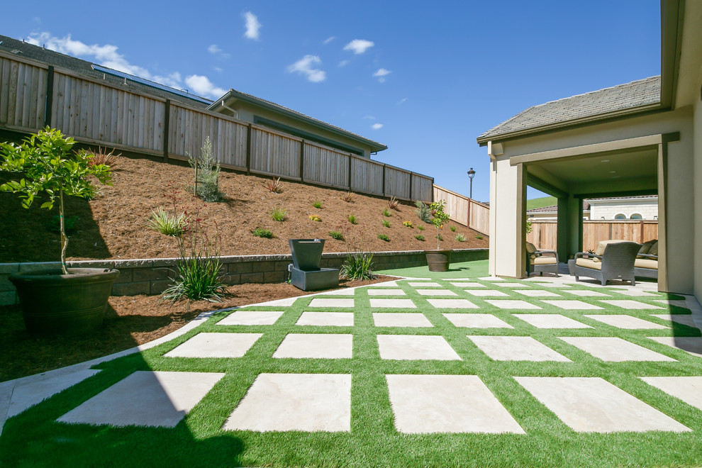 Mid-sized trendy backyard concrete paver patio photo in San Francisco with a roof extension