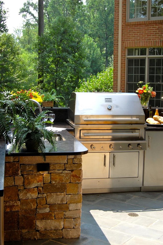 This is an example of a medium sized classic back patio in Chicago with an outdoor kitchen.