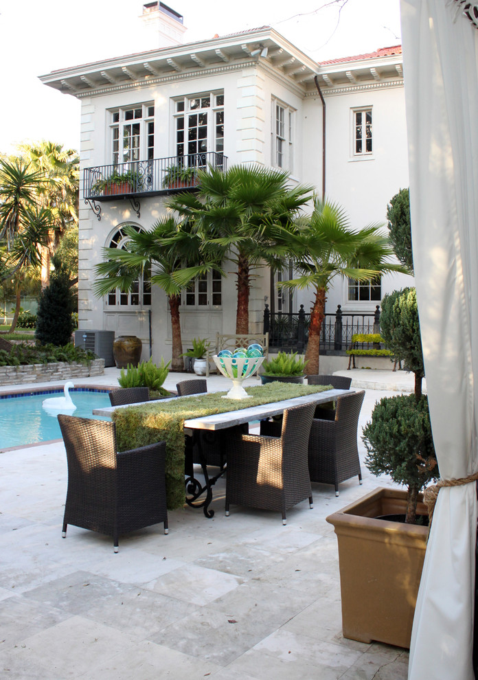 Inspiration for a large bohemian back patio in Houston with tiled flooring and a pergola.