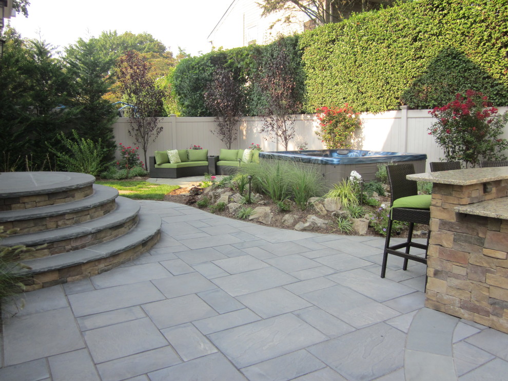 Small contemporary back patio in New York with an outdoor kitchen and concrete paving.