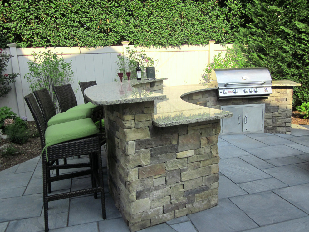 Inspiration for a small contemporary backyard concrete paver patio kitchen remodel in New York