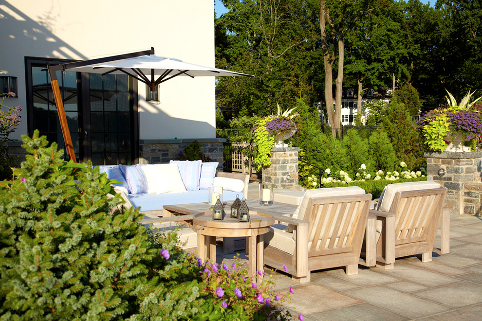 Diseño de patio clásico renovado grande en patio trasero con jardín de macetas, adoquines de piedra natural y toldo