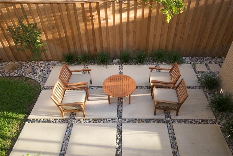 Inspiration for a large modern courtyard stone patio remodel in Dallas with no cover