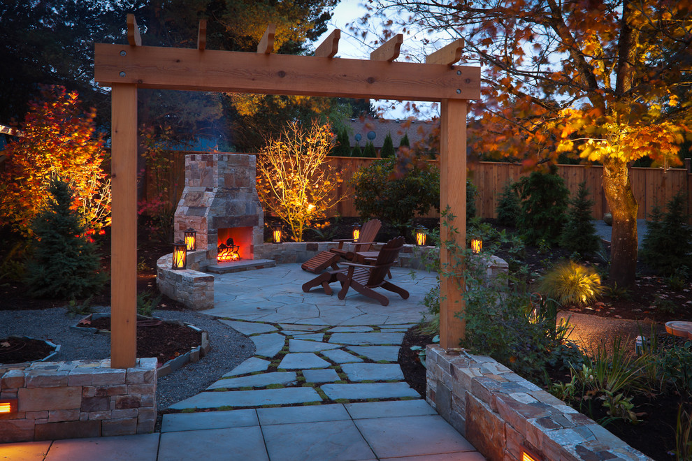 Example of a classic patio design in Portland with a fire pit and a pergola