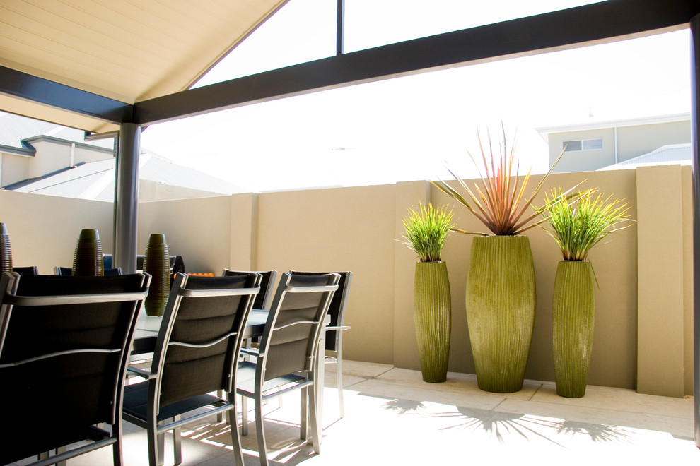 Example of a mid-sized minimalist backyard tile patio kitchen design in Perth with a pergola