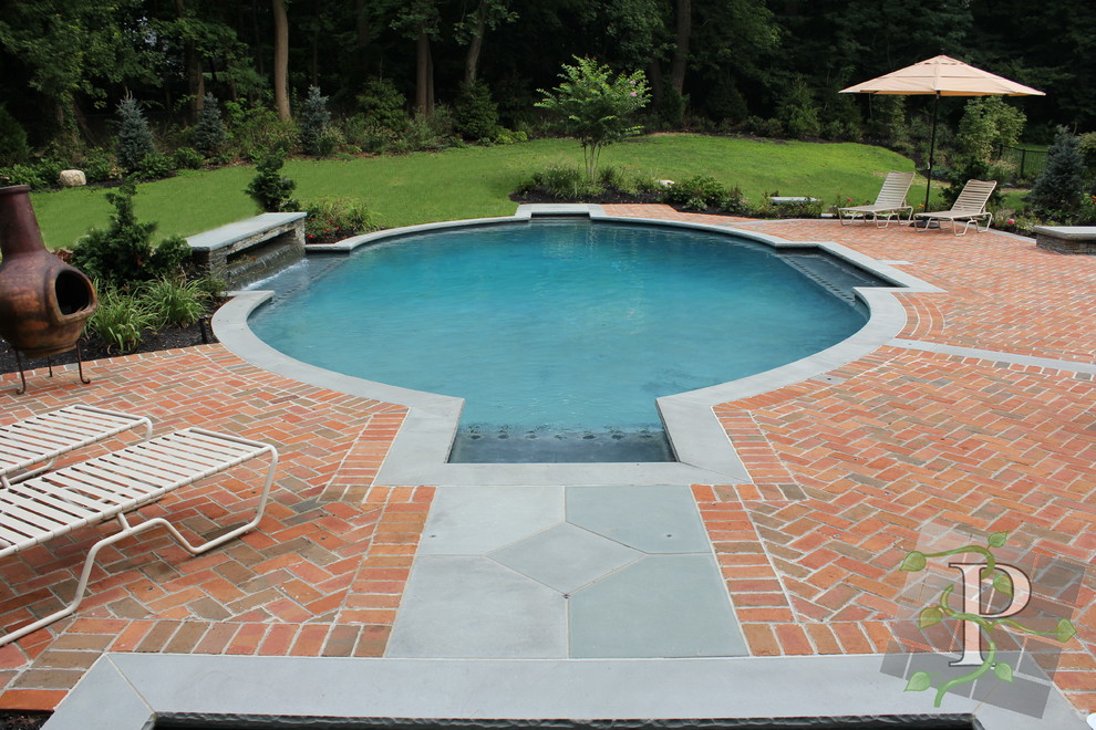 Foto di una piscina tradizionale di medie dimensioni e dietro casa con pavimentazioni in mattoni