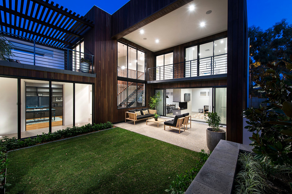 Photo of a contemporary courtyard patio in Perth with a roof extension.