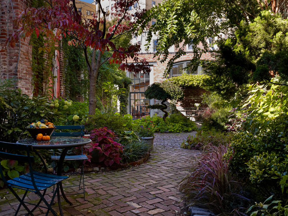 Inspiration for an industrial courtyard brick patio remodel in Philadelphia