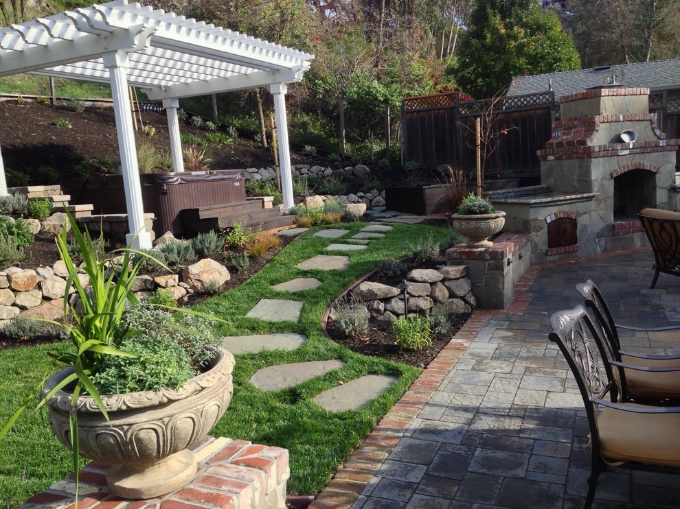 Mid-sized elegant backyard stone patio photo in San Francisco with a fire pit and a pergola