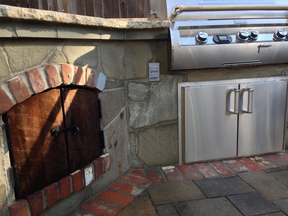 Inspiration for a mid-sized timeless backyard concrete paver patio kitchen remodel in San Francisco with a pergola