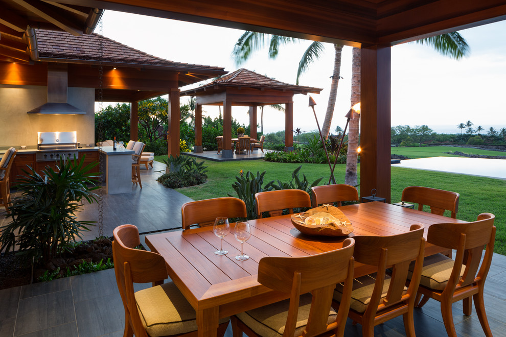 Patio - tropical backyard patio idea in Hawaii with a roof extension