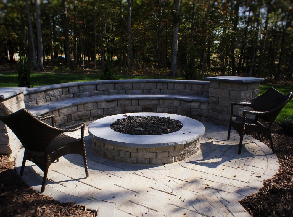 Photo of a small traditional back patio in Richmond with a fire feature and concrete paving.