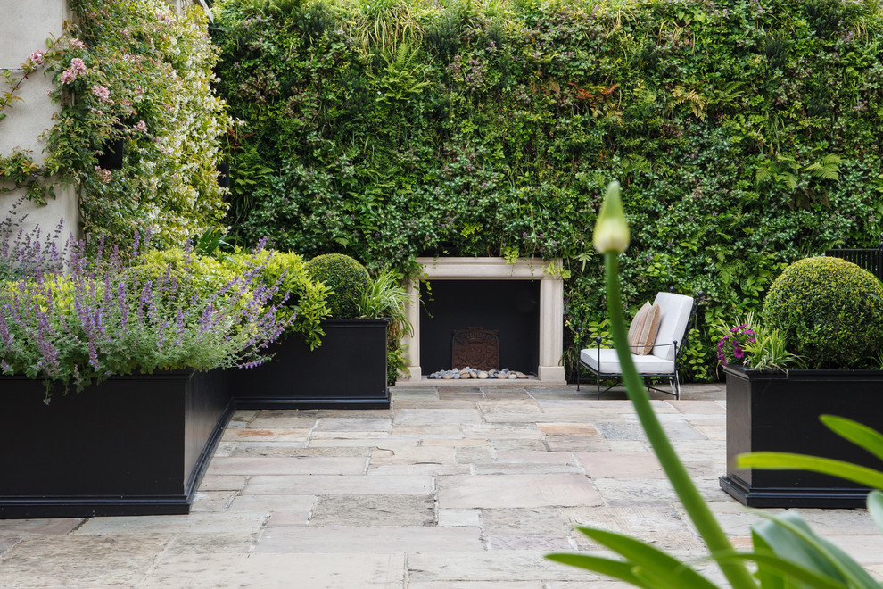 Inspiration for a timeless courtyard stone patio vertical garden remodel in London
