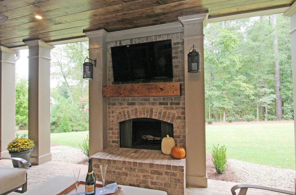 Medium sized classic back patio in Atlanta with a fireplace, brick paving and a roof extension.