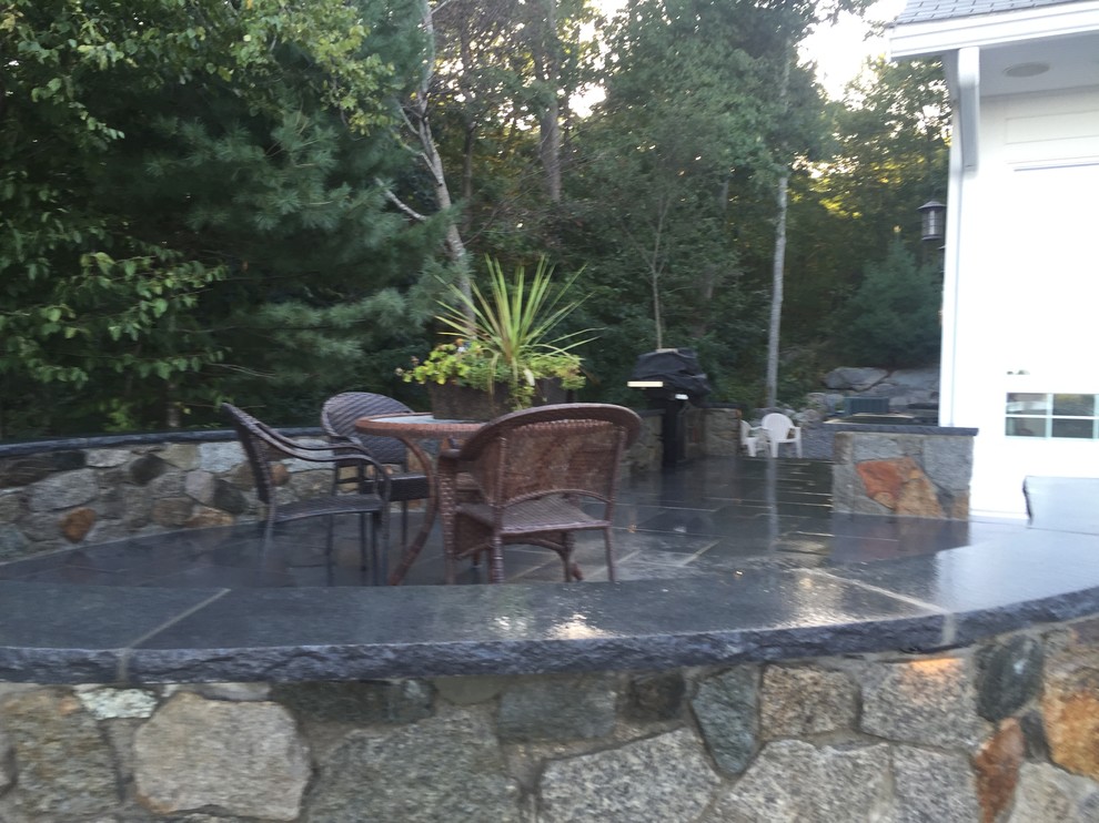 Inspiration for a mid-sized modern backyard tile patio remodel in Boston with no cover
