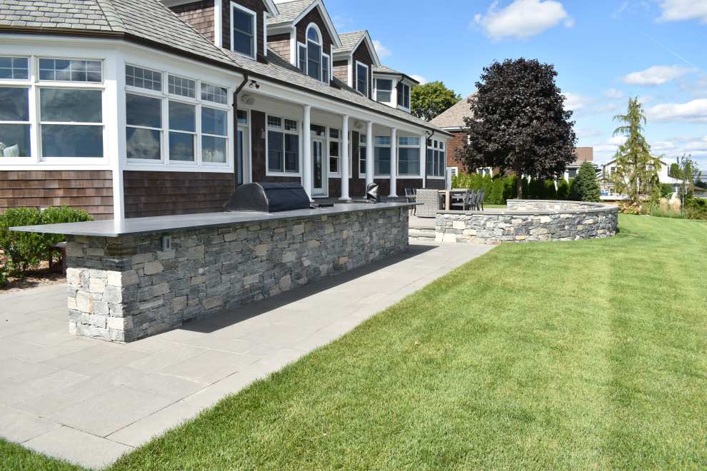 Idee per un grande patio o portico classico dietro casa con pavimentazioni in pietra naturale e nessuna copertura